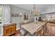Elegant dining room featuring a large wooden table, chandelier lighting, and stylish decor for entertaining at 7820 Seville Cir, Bradenton, FL 34209