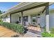 Charming front porch with decorative dog statues and cozy seating area at 7820 Seville Cir, Bradenton, FL 34209