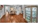 Hallway boasts hardwood flooring, display cases, and views into multiple rooms at 7820 Seville Cir, Bradenton, FL 34209