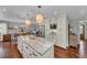 Spacious kitchen island with marble countertops, pendant lighting, and ample storage space for culinary enthusiasts at 7820 Seville Cir, Bradenton, FL 34209