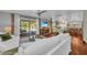 Bright open concept living room with wood floors and view of the pool and back yard at 7820 Seville Cir, Bradenton, FL 34209