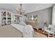 Spacious main bedroom with hardwood floors, chandelier, and views of the en suite bathroom at 7820 Seville Cir, Bradenton, FL 34209