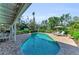 Inviting backyard pool area with lounge chairs, manicured landscaping, and a covered patio for outdoor living at 7820 Seville Cir, Bradenton, FL 34209