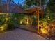 Inviting backyard patio area with pergola and lush tropical landscaping at 1330 N Lockwood Ridge Rd, Sarasota, FL 34237