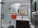 Modern bathroom with glass shower, stylish vanity, and unique artwork at 1330 N Lockwood Ridge Rd, Sarasota, FL 34237