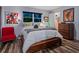 Comfortable bedroom with a wooden platform bed, wood floors, and a modern aesthetic at 1330 N Lockwood Ridge Rd, Sarasota, FL 34237