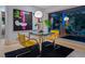Cozy dining area with modern art and a view of lush greenery at 1330 N Lockwood Ridge Rd, Sarasota, FL 34237