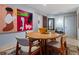 Cozy dining area with a round table, surrounded by colorful, modern artwork at 1330 N Lockwood Ridge Rd, Sarasota, FL 34237