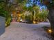 Long gravel driveway surrounded by mature trees leading to the home and garage at 1330 N Lockwood Ridge Rd, Sarasota, FL 34237