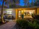 Home exterior featuring a brick pathway and tropical plants at 1330 N Lockwood Ridge Rd, Sarasota, FL 34237