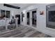 Bright studio space with art supplies, modern lighting, and stylish gray wood floors at 1330 N Lockwood Ridge Rd, Sarasota, FL 34237