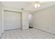 Spacious bedroom with tile flooring, a closet, and an access door with an unfinished transition at 147 Whispering Sands Dr # V29, Sarasota, FL 34242