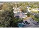 Aerial view shows a home with a screened enclosure, lush landscaping, and a neighboring property with a sparkling pool at 2111 152Nd E Ct, Bradenton, FL 34212