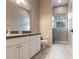 Bathroom with single sink vanity, tiled floor, and glass shower at 2111 152Nd E Ct, Bradenton, FL 34212