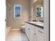 Bright bathroom featuring tile floors, granite counters, and a window providing natural light at 2111 152Nd E Ct, Bradenton, FL 34212