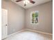 Bedroom features tile flooring, natural light, and a ceiling fan at 2111 152Nd E Ct, Bradenton, FL 34212