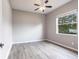 Neutral bedroom with grey plank flooring and natural light at 2111 152Nd E Ct, Bradenton, FL 34212