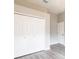 Bedroom features spacious closet and gray plank flooring at 2111 152Nd E Ct, Bradenton, FL 34212