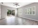 Light-filled bedroom features luxury vinyl plank flooring, plantation shutters, and sliding glass doors at 2111 152Nd E Ct, Bradenton, FL 34212