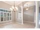 Formal dining area with plantation shutters, tile flooring, and decorative chandelier lighting at 2111 152Nd E Ct, Bradenton, FL 34212