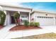Charming front entrance featuring a well-kept lawn and mulched flower beds leading to a cozy porch at 2111 152Nd E Ct, Bradenton, FL 34212