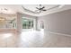 Spacious living room with large tile flooring, tray ceiling, and sliding glass doors to the pool at 2111 152Nd E Ct, Bradenton, FL 34212