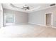 Open living room with tile flooring, neutral walls, and multiple access points at 2111 152Nd E Ct, Bradenton, FL 34212