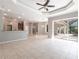 Open floor plan with tile flooring, kitchen bar, and sliding glass doors leading to a lanai at 2111 152Nd E Ct, Bradenton, FL 34212