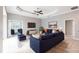 Bright living room featuring a modern blue sofa, coffered ceiling, and neutral color palette at 2111 152Nd E Ct, Bradenton, FL 34212