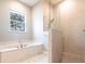 Bright bathroom with soaking tub and glass enclosed shower stall at 2111 152Nd E Ct, Bradenton, FL 34212
