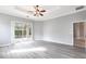 Spacious primary bedroom boasts plank flooring, large windows and pool access at 2111 152Nd E Ct, Bradenton, FL 34212