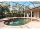 Inviting in-ground pool featuring a screened enclosure and beautiful brick patio at 2111 152Nd E Ct, Bradenton, FL 34212