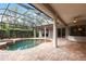 Inviting in-ground pool featuring a screened enclosure and beautiful brick patio at 2111 152Nd E Ct, Bradenton, FL 34212
