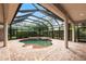 Indoor screened-in pool with brick pavers and lush greenery, perfect for year-round enjoyment at 2111 152Nd E Ct, Bradenton, FL 34212