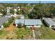 Aerial view of a cozy home with a metal roof, surrounded by lush greenery and trees at 2302 8Th W Ave, Bradenton, FL 34205