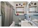 Retro blue bathroom featuring beautiful tile, vanity, and shower at 2302 8Th W Ave, Bradenton, FL 34205