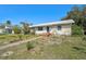 Cozy single-story home showcasing a blue front door and simple landscaping at 2302 8Th W Ave, Bradenton, FL 34205
