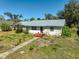 Charming home featuring a metal roof, well-maintained lawn, and inviting curb appeal at 2302 8Th W Ave, Bradenton, FL 34205