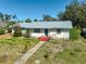 Charming home featuring a metal roof, well-maintained lawn, and inviting curb appeal at 2302 8Th W Ave, Bradenton, FL 34205