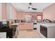 The pink kitchen features ample cabinet space, and updated appliances at 2302 8Th W Ave, Bradenton, FL 34205