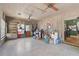 Spacious living room with wood paneling, ceiling fans, built-in shelves, and a view to an adjacent room at 2302 8Th W Ave, Bradenton, FL 34205