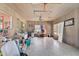 Large living room featuring wood paneling, ceiling fans, natural light, and a view into other rooms at 2302 8Th W Ave, Bradenton, FL 34205