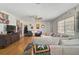 Spacious living room featuring hardwood floors, a ceiling fan, and a comfortable sectional sofa at 2302 8Th W Ave, Bradenton, FL 34205