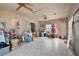 Bright and airy living room with wood paneling, ceiling fans, and natural light from the windows at 2302 8Th W Ave, Bradenton, FL 34205