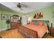 The primary bedroom features hardwood floors, art and plenty of natural light at 2302 8Th W Ave, Bradenton, FL 34205