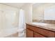 This full bathroom features a shower-tub combo, a single sink vanity and tile flooring at 2347 Richwood Pike Dr, Ruskin, FL 33570