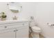 Half bathroom with a white vanity, round mirror, and a standard toilet at 2347 Richwood Pike Dr, Ruskin, FL 33570