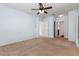 Bright bedroom with neutral carpet, ceiling fan, and access to en-suite bathroom and closet at 2347 Richwood Pike Dr, Ruskin, FL 33570