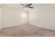 Bedroom with neutral walls, carpet flooring, ceiling fan, and natural light from the window at 2347 Richwood Pike Dr, Ruskin, FL 33570