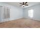 Bright and spacious bedroom with neutral carpet, ceiling fan, and two windows allowing natural light at 2347 Richwood Pike Dr, Ruskin, FL 33570